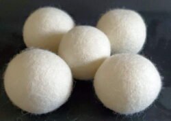 Do Dryer Balls Work? | Just a Small Change Wool Dryer Balls on black table available at justasmallchange.com